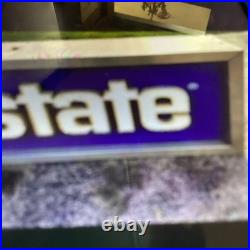 Vintage Allstate Light Up Can Sign Hung On Side Of Building