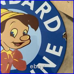 Vintage Standard Gasoline Pinocchio Walt Disney 12 Inch Porcelain Enamel Sign